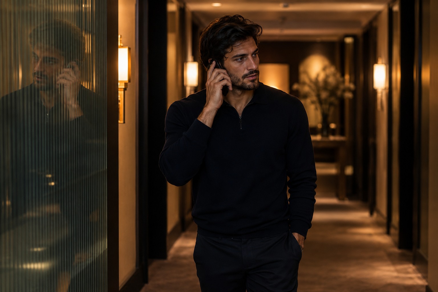 An athlete listening to a voice call in a quiet hotel hallway